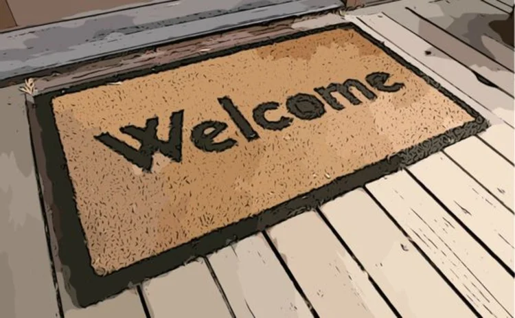 A welcome mat in front of a door